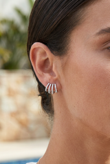 4 row huggie earrings — earrings lifestyle shot, Close-up of a woman's ear wearing the earring, hair tucked back