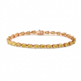 Yellow gold is the right choice here. It deepens the saturation of these pear cut yellow d — rose gold bracelet, front view packshot