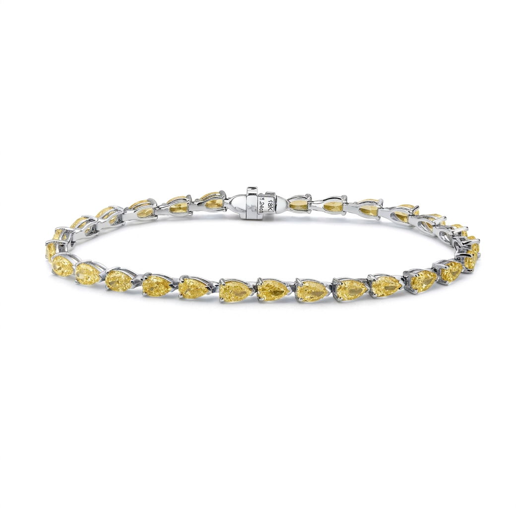 Yellow gold is the right choice here. It deepens the saturation of these pear cut yellow d — white gold bracelet, front view packshot
