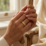 **A RADIANT LEGACY CAPTURED IN GOLD** — ring lifestyle shot, Two hands gently clasped, ring prominently displayed