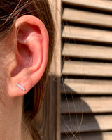 Lifestyle - 5 stone diamond bar earring on ear in 18k white gold