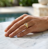 Lifestyle - Pear shape knot ring in 18k yellow gold on finger.