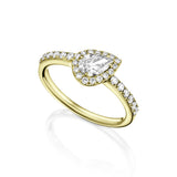 A yellow gold ring featuring a tilted pear-cut center stone with a delicate halo and a half setted band in 18k yellow gold. 
