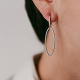 Lifestyle - Diamond hoops with oval hanging motive in 18k white gold