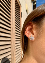 Lifestyle - Diamond snowflake earrings on ear in white gold