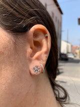 Lifestyle - Open flower studs set with diamonds on leafs in white gold on ear 