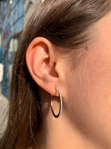 Lifestyle - Oval designed diamond hoops on ear in white gold 