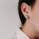 Lifestyle - Pave setting cushin diamond earrings on ear in white gold 