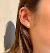 Lifestyle - A pair of rose gold diamond pave flower earrings on ear