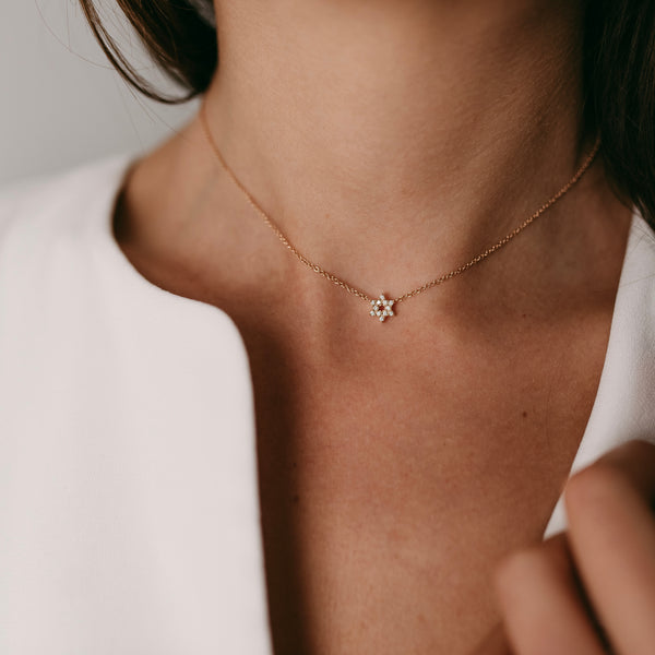 Mini star of david diamond necklace on neck
