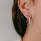 Lifestyle - twisted diamond earrings in white gold 18k on ear 